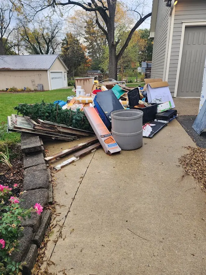 Dumpster being loaded with debris for Roofing Dumpster Rental in Mentone